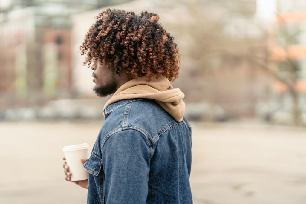 A man with beautiful, voluminous curly hair.
